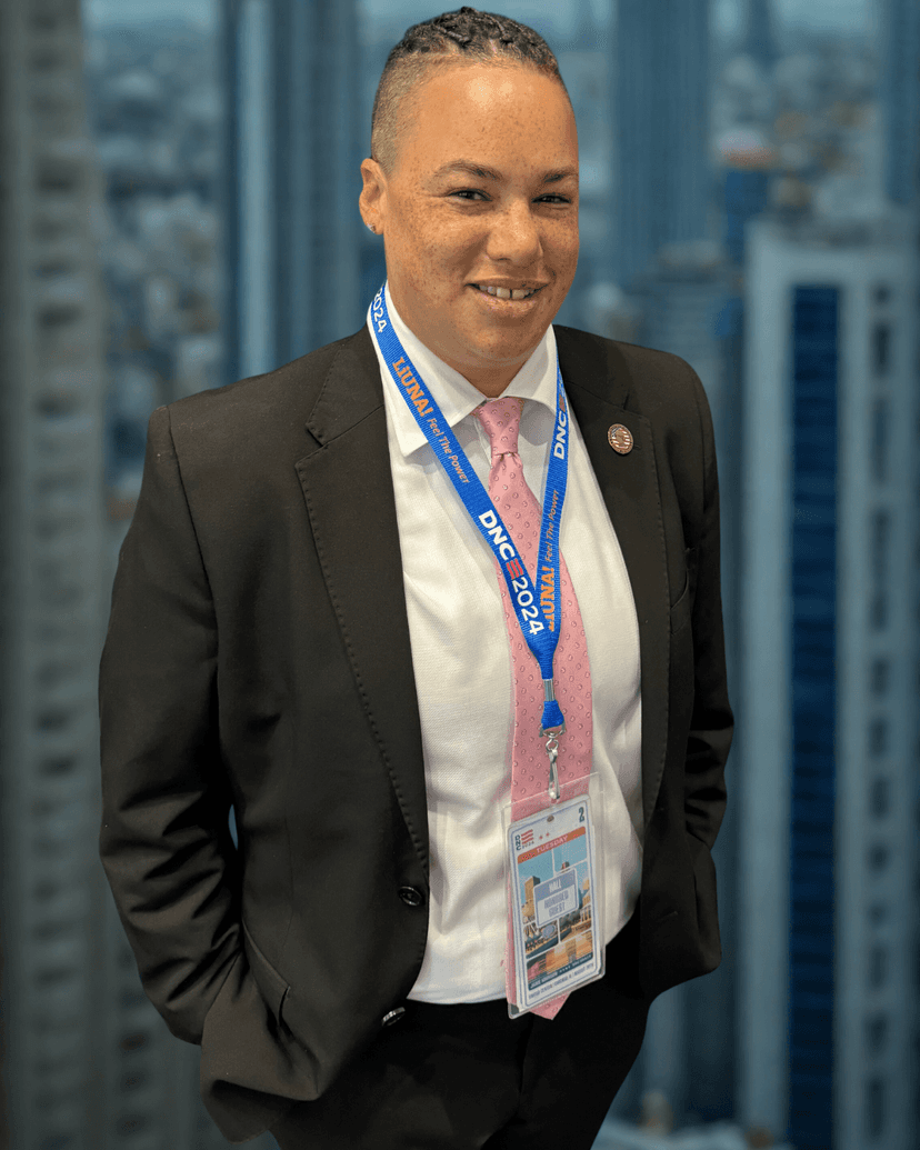 A man in a suit and tie standing in front of a cityscape