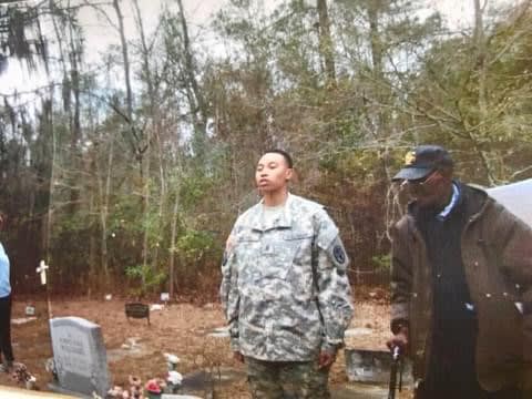 A group of men standing around a cemetery