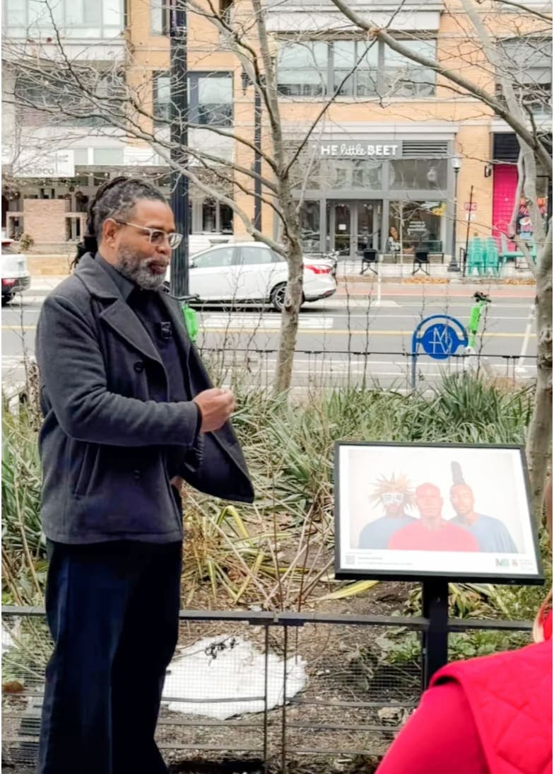 A man standing in front of a sign