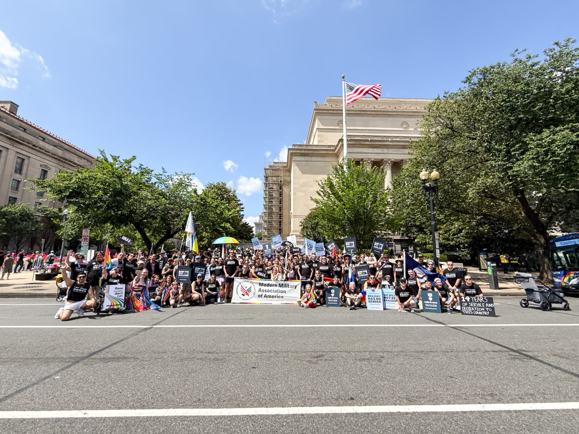 A group of people sitting on the side of a road