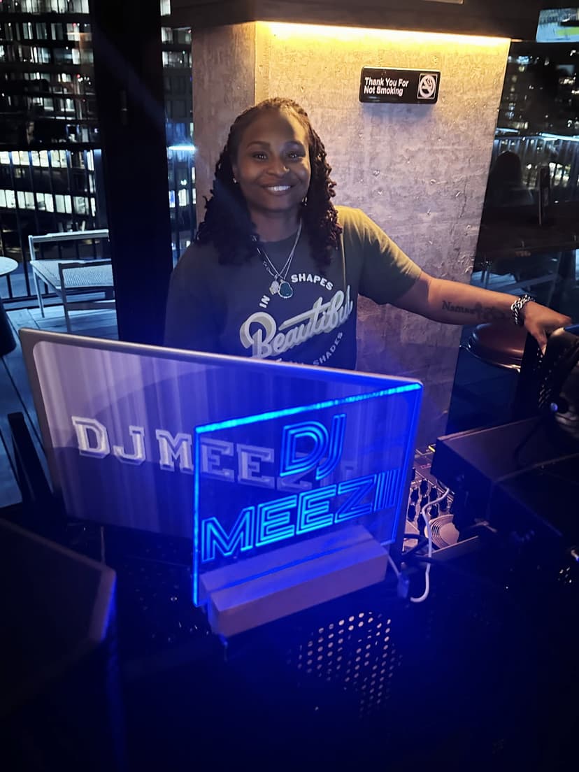 A woman standing in front of a dj booth