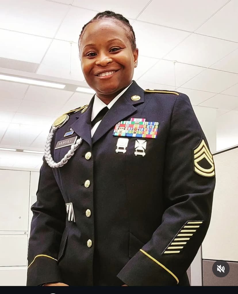A woman in a military uniform standing in a room